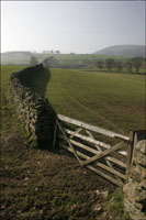 Wooden gate set into a drystone wall